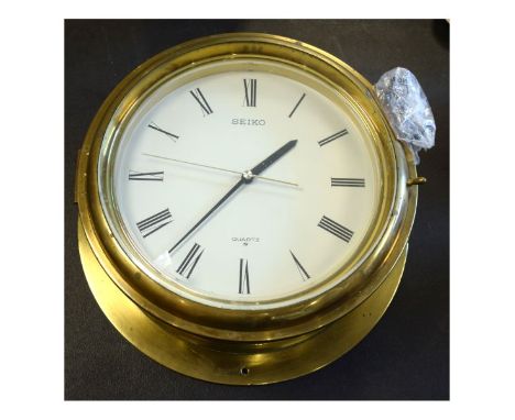 Seiko quartz wall clock in the form of a ships bulkhead timepiece, with drum housing   Condition: 