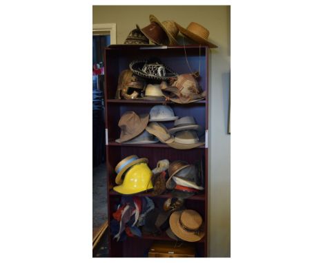 Large selection of various hats to include; fireman's type hat with yellow painted finish, deerstalker, military helmet, stra