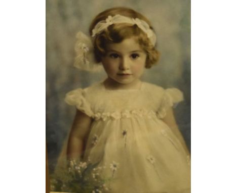 Early 20th Century tinted photographic portrait of a young girl as a bridesmaid, 32cm x 22.5cm, in gilt card mount and gilt f
