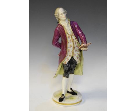 Late 19th Century Continental porcelain figure depicting a standing nobleman reading from a book, marked with a painted under