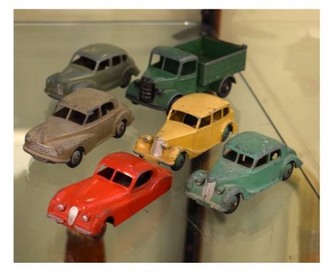 Five vintage Dinky die-cast cars comprising: Austin Devon, Morris Oxford, Triumph, Jaguar and Riley together with a similar B