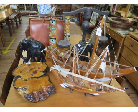 A carved wood pair of scales, two scale models of dhow, 78 cm and 56 cm long, a pair of model totem poles, a pair of carved e