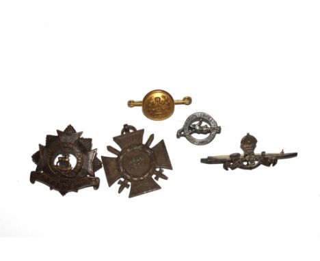 A Bedfordshire Regiment cap badge, a Light Infantry brooch, a World War I medal and two other brooches 