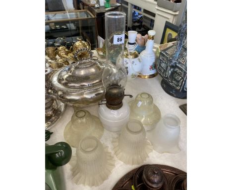 Two green glass shades and an oil lamp