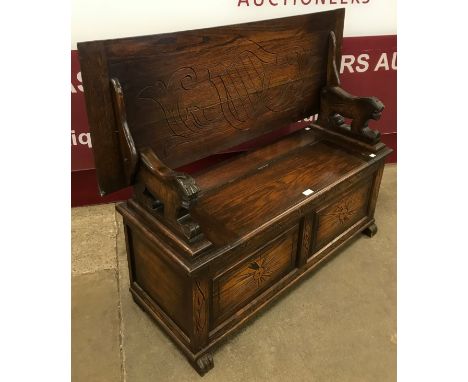 An early 20th Century carved oak monks bench 
