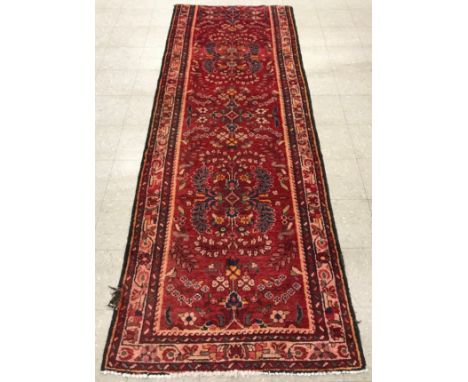An Iranian red ground rug/runner, 306 x 110cm