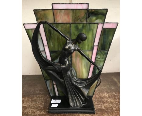 An Art Deco style figural table lamp, with stained glass back