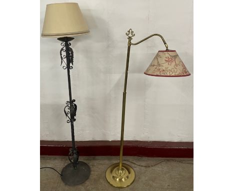 A wrought steel standard lamp and a brass standard lamp 