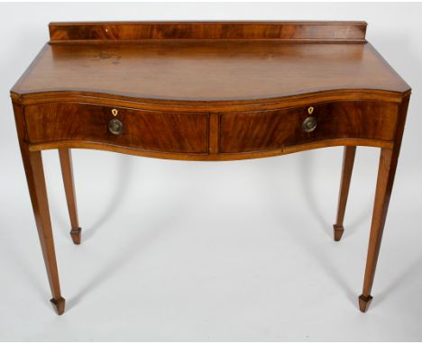 A Regency style mahogany and cross banded serpentine serving table, with raised back and two cock beaded drawers, Hamptons, L