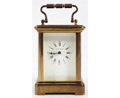 A miniature French brass carriage timepiece, the dial inscribed London Clock Co, with key, 8cm high (exc handle)