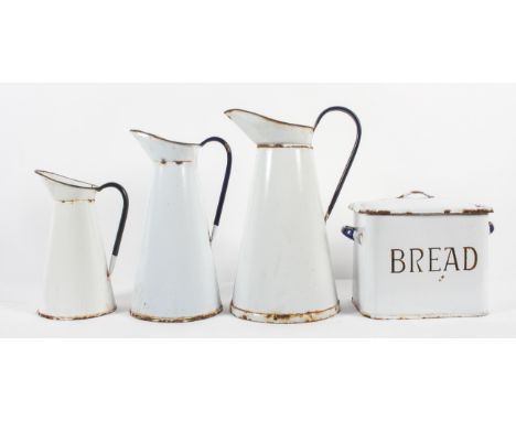 A collection of vintage enamelled kitchenalia, comprising : three tapering conical jugs, in graduating sizes, one with crowne