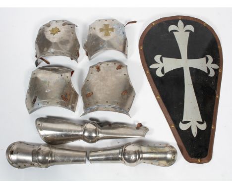 A vintage children's suit of armour, comprising : four cuirass, arm vambrace-couter fittings and a Crusader's shield, bearing