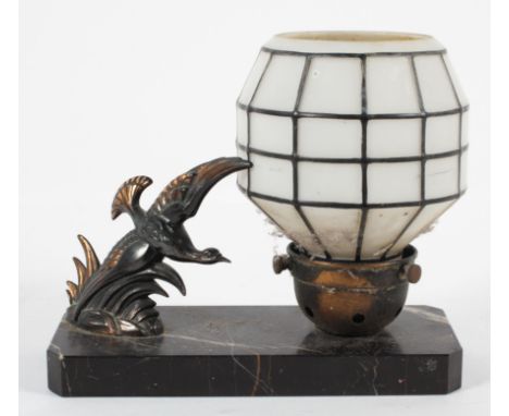An Art Deco style lamp, modelled as a bird in flight next to a white glass amp on a black marble base, 20cm long