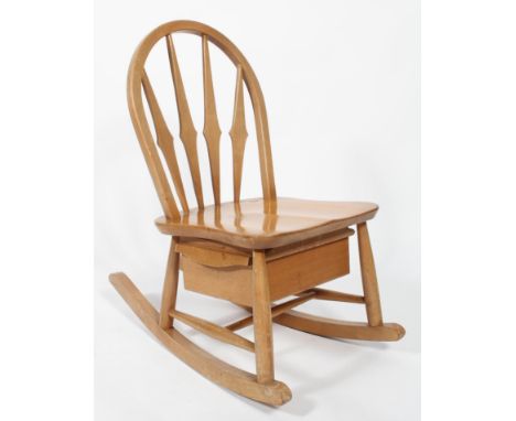 A mid 20th century Ercol beech and elm child's rocker/rocking chair with drawered seat