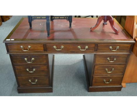 A George III style mahogany pedestal desk Writing surface with small areas of loose leather. A few light scuffs and scratches