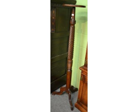 A Georgian style mahogany torchere stand, wrythen column, tripod base