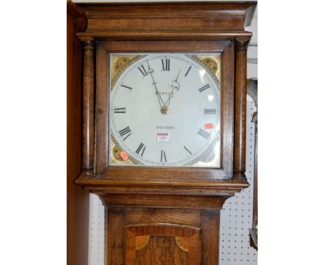 An oak long case clock, the painted dial signed Rowell, Oxford, with 30 hour movement, pendulum and single weight