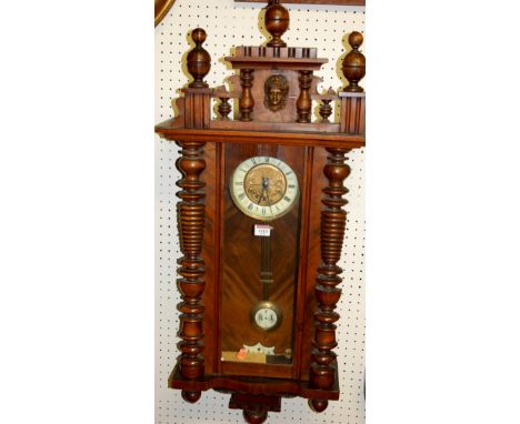 An early 20th century Vienna type walnut drop trunk wall clock