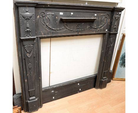 An Edwardian Classical style cast iron fire surround, in the manner of Robert Adam, 140cm high, 146cm wide, complete with a b