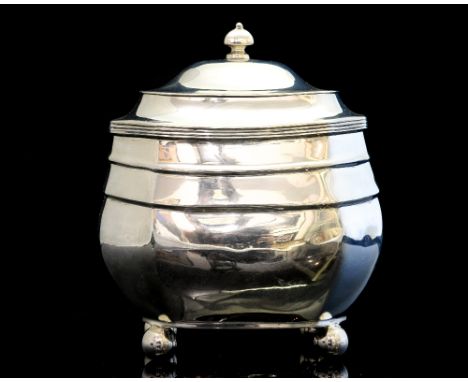 A George V silver tea caddy, modelled in the George III style of circa 1810, resting atop four ball feet, with hinged cover s