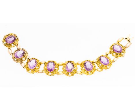 A Victorian amethyst and yellow gold bracelet comprising eight oval pierced links, each with oval faceted amethyst to the cen