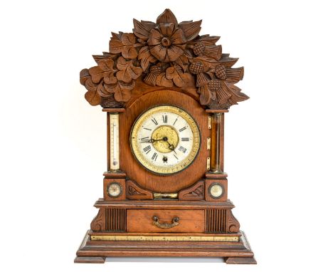 A late Victorian oak cased bracket clock, manufactured by the British United Clock Company, fitted with an integrated thermom