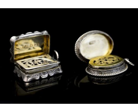 Two Victorian silver vinaigrettes with hinged grilles and gilt interior, one of oval form with floral and foliate decoration,