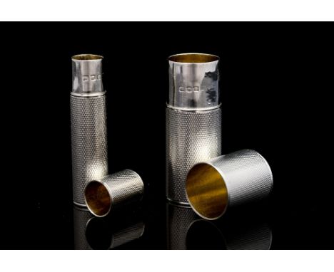 Two George V silver needle cases, each with engine turned decoration and removable cover, Asprey, London 1937, height of larg