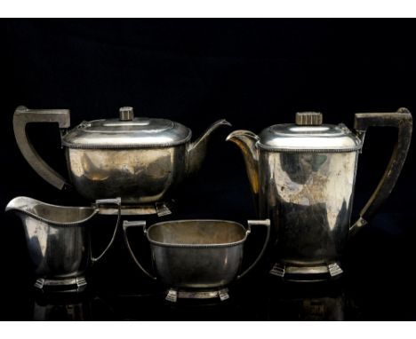 An Edward VIII art deco silver four piece tea service, comprising teapot, hot water jug, two handle sugar bowl and milk jug, 