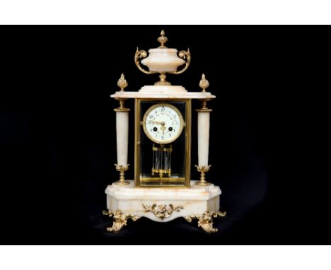 A late 19th century eight day marble mantle clock, applied gilt embellishments and a marble urn finial, white enamelled dial,