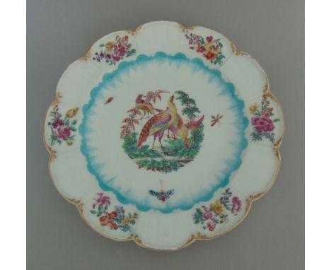 A Chelsea gold anchor lobed plate, with alternate engine turned and floral decorated panels on the rim, the centre painted wi