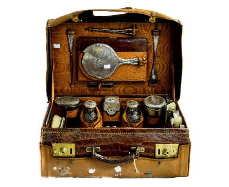 A George V leather fitted travelling case, the interior featuring twenty-three silver and leather accouchements to include, t