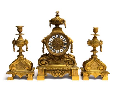 A French gilt metal clock garniture, circa 1870, of Baroque design, urn finial, 12cm circular dial with inset enamel Roman nu