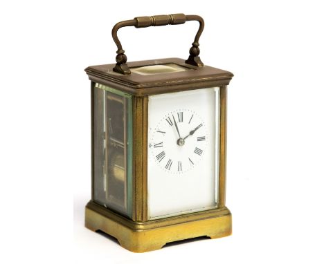 A French brass carriage clock, circa 1900, corniche case, white enamel dial with Roman numerals, visible escapement, the move