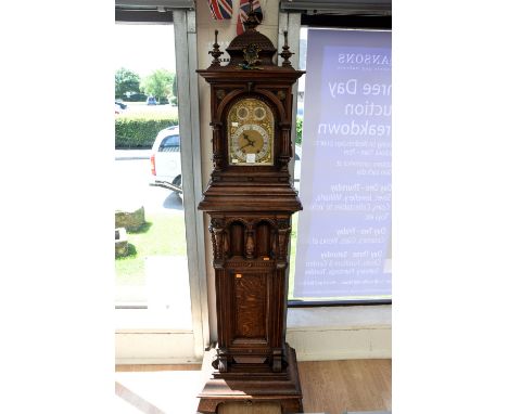  A mid Victorian oak cased eight day town hall clock in the Renaissance Revival style, the upper section with a caddy top and