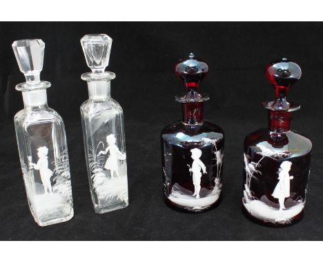 Pair of cranberry glass small decanters, of cylindrical mallet form, with onion stoppers, each decorated in 'Mary Gregory' st