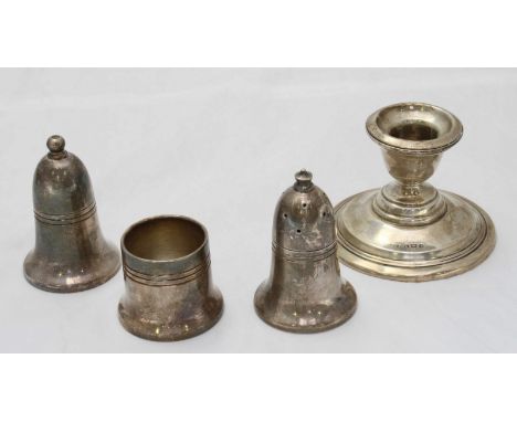 A silver squat candlestick, date marked Birmingham, 1918, together with a three piece silver plated condiment set.