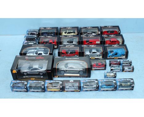 A collection of thirty boxed scale models of cars including, a Lamborghini Diablo, a Mercedes SL55 AMG and a BMW Z8 among man