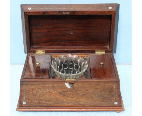 A 19th century rosewood sarcophagus tea caddy, the hinged top opening to reveal a fitted interior and glass bowl, the exterio