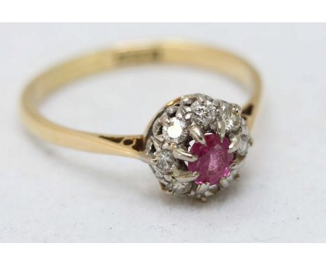 An 18ct gold diamond and ruby ring, the claw set ruby surrounded by eight smaller diamonds, ring size P, total weight 2.8g