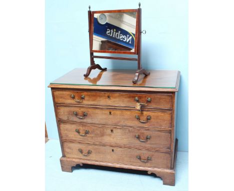 A 19th century mahogany chest of four long graduated drawers with brass pulls, flush brass escutcheons and raised on shaped b