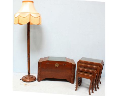 A mid 20th century Oriental carved camphor wood blanket box, together with a matching nest of four glass-top occasional table