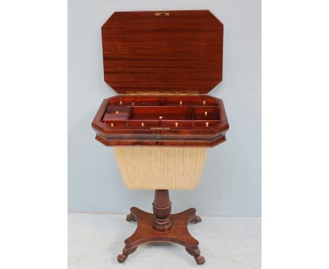 A late Georgian mahogany ladies work table of elongated octagonal form, the hinged top enclosing a compartmented interior wit