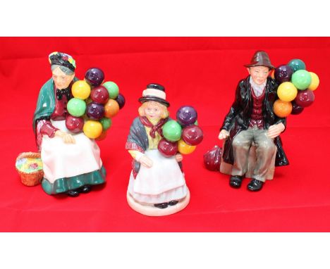 Three Royal Doulton ceramic figures including 'The Old Balloon Seller, HN1315,' 'Balloon Girl, HN2818' and 'The Balloon Man, 