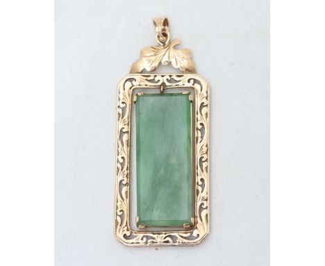 A 14ct gold pendant with rectangular cut Jade slab set to middle, the gold frame ornately engraved with floral designs, total