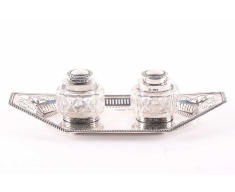 An Edwardian silver two bottle inkstand. London 1906 by the gold and silversmiths company. The rectangular lozenge base with 