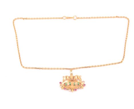 An Indian yellow metal pendant, with red and white paste stones inset (some lacking), and enamel decoration, suspended on a h