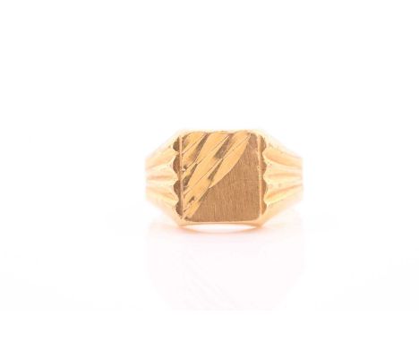 A yellow metal signet ring, with engraved decoration and shaped shoulders, marked 916 to shank, size P.Condition report: 5.3 