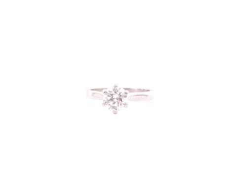 A single stone diamond ring; the round brilliant cut diamond in simple six claw mount above a plain platinum shank with taper