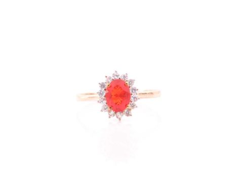 A 9ct yellow gold, fire opal, and white topaz cluster ring, the opal measuring approximately 8.2 x 6.2 mm, size W (could be r